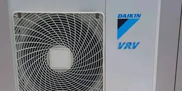 A daikin air conditioner is sitting in front of the logo.