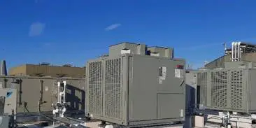 A large air conditioner unit on top of a building.