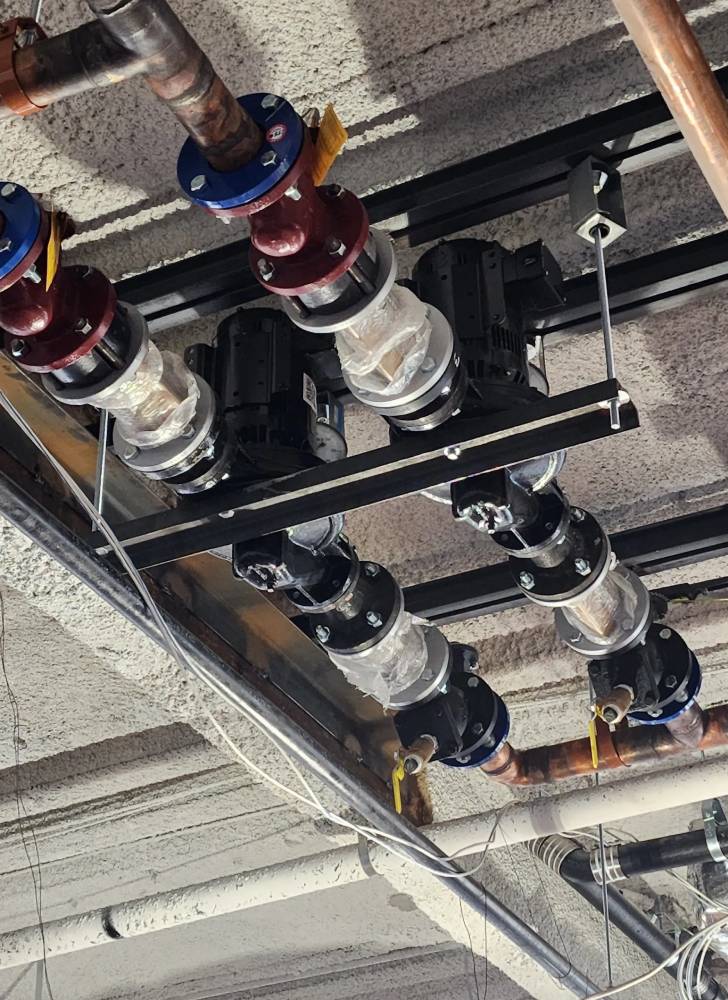 A bunch of pipes hanging from the ceiling