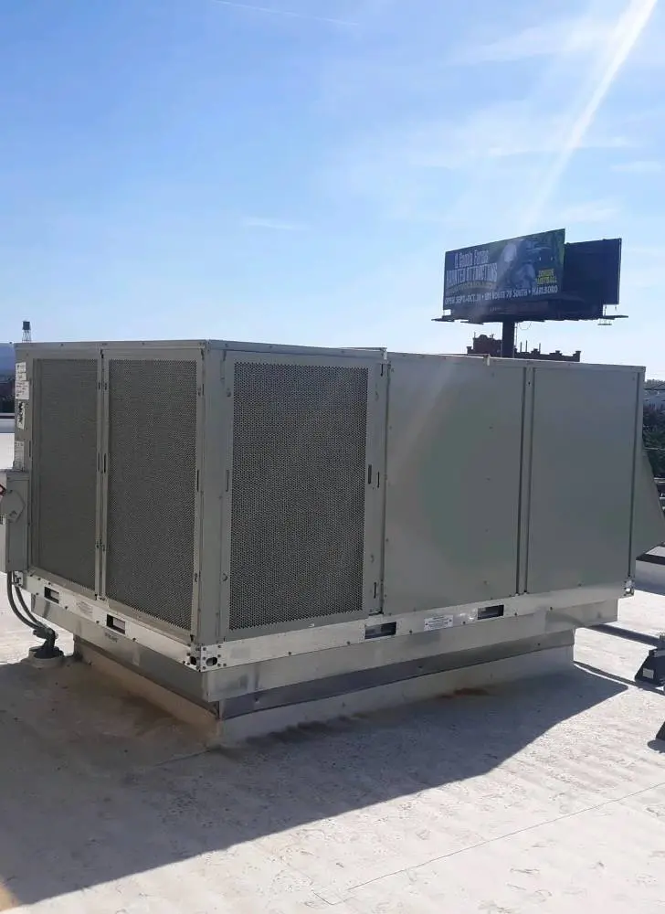 A large air conditioner unit on top of a building.
