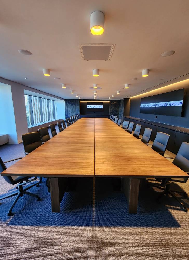 A large conference table with chairs around it.