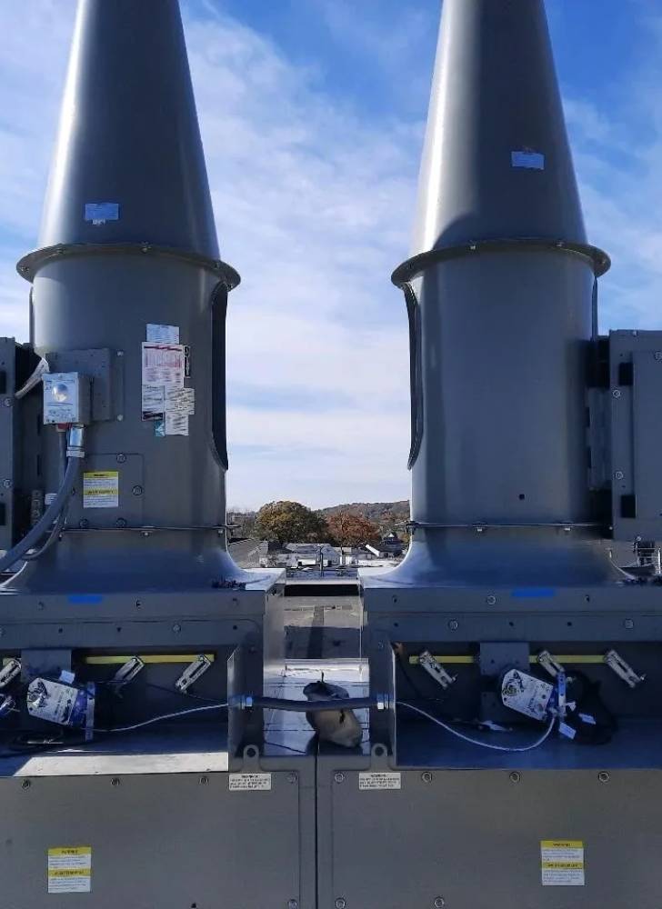 Two large gray tanks sitting on top of a dock.